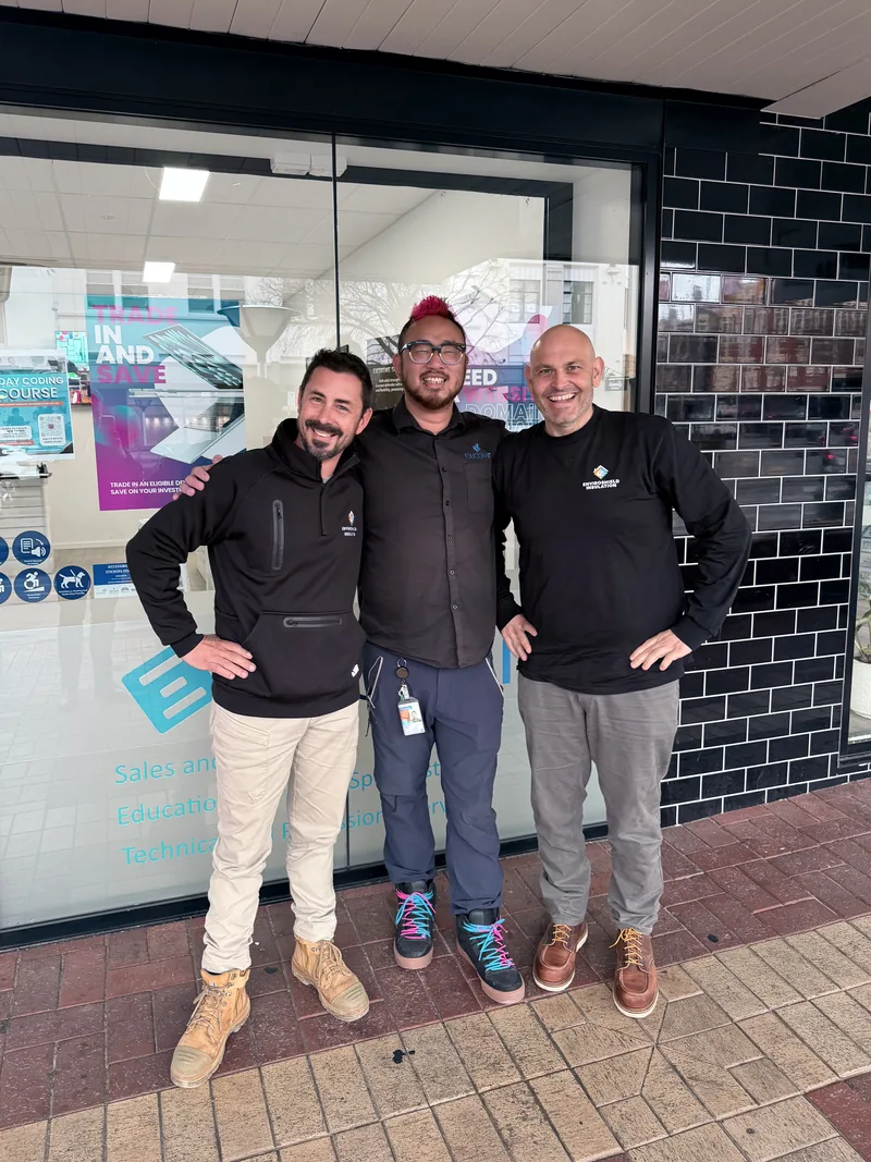 Two members of the EnviroShield Insulation team with an EduCom IT staff member outside the EduCom IT store on Dean Street, Albury.
