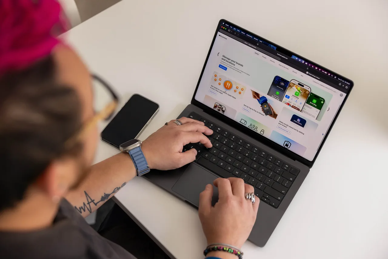 A Tonkin team member working on an Apple Business Manager device