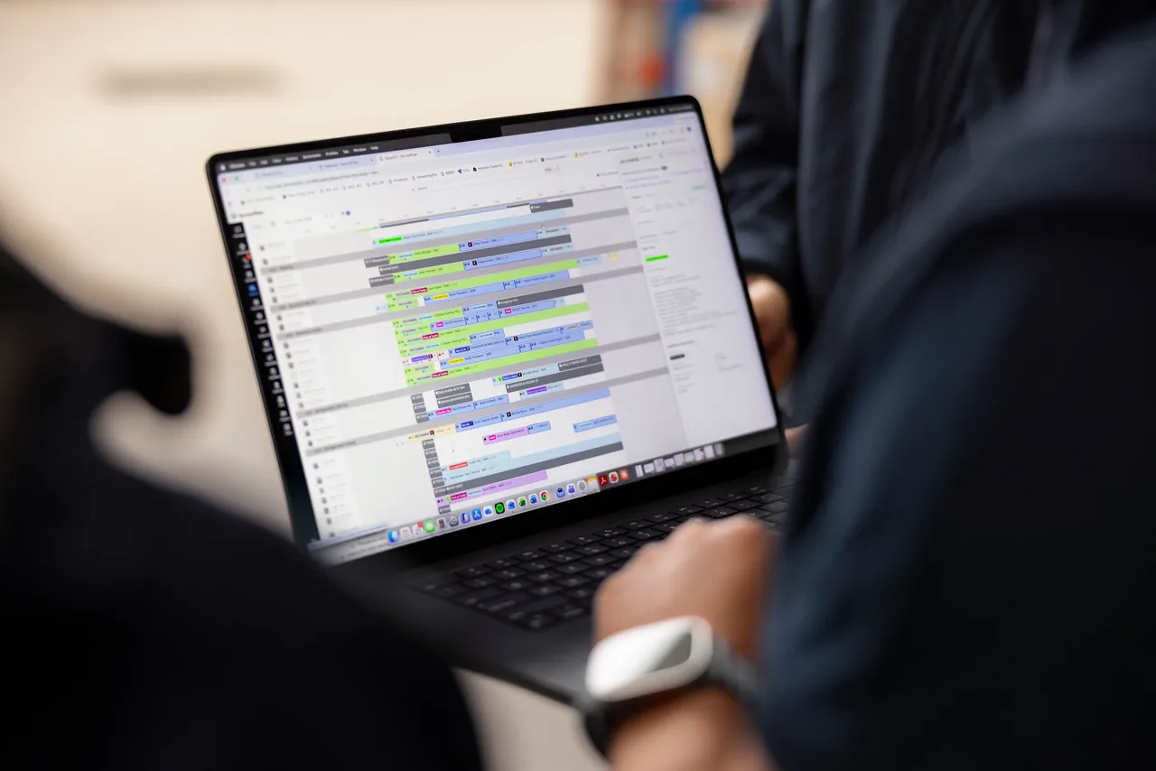 A Tonkin team member reviewing project scheduling on a MacBook