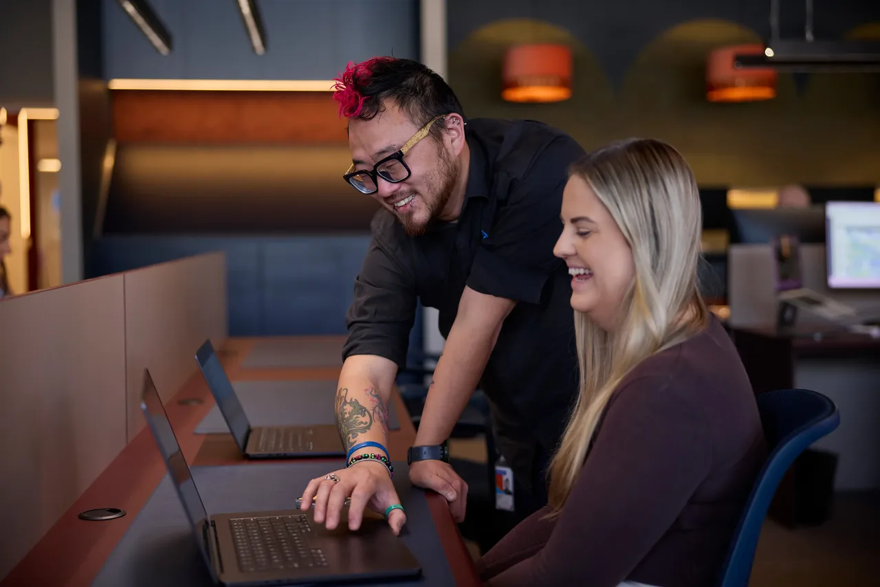 Tonkin team members working together on MacBooks
