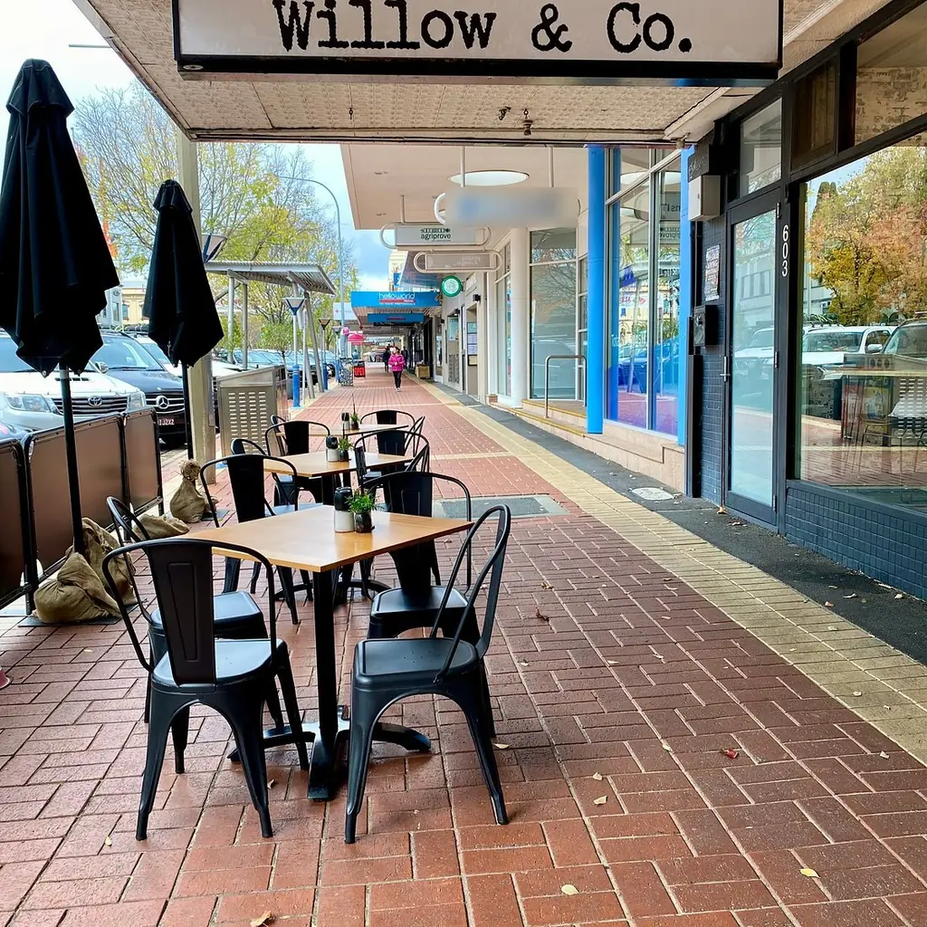 The Willow & Co. shopfront on Dean Street, Albury, with the hand-painted wordmark above the awning and tables set out on the footpath.